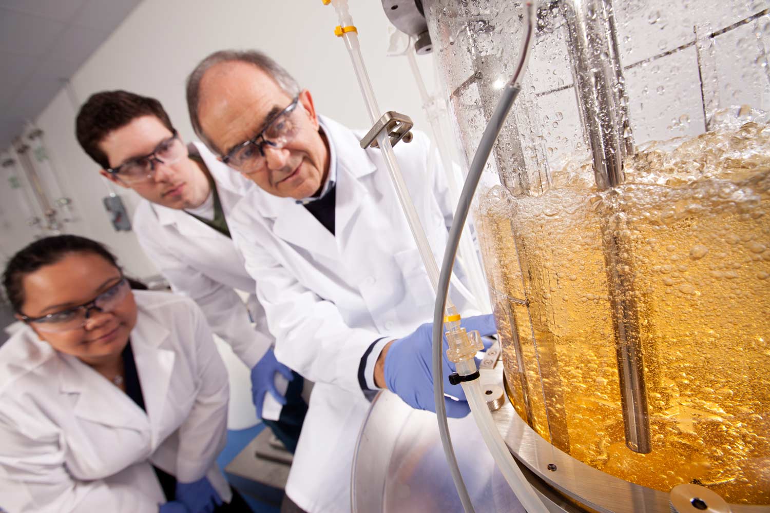 Texas A&M professor and student researchers watch an experiment in action