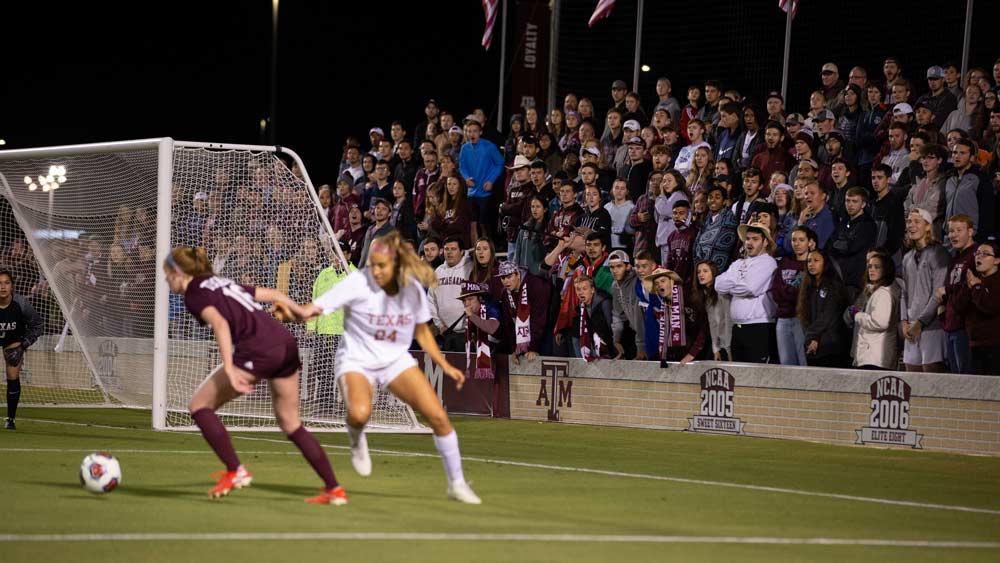 Women's soccer players in front of the goal