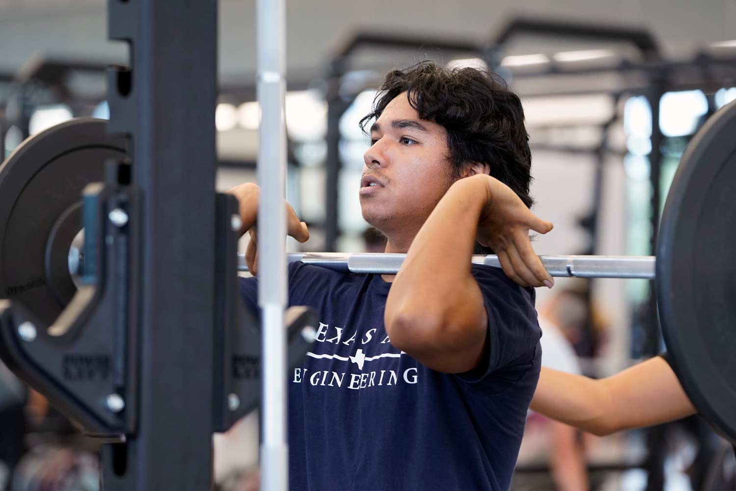 Aggie lifts weights in the rec center